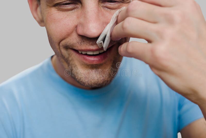 Happy smiling man sniffing teabag smell after end of virus illness. Aromatic revival: Recovering the lost sense of smell. Happy smiling man sniffing teabag smell after end of virus illness. Aromatic revival: Recovering the lost sense of smell