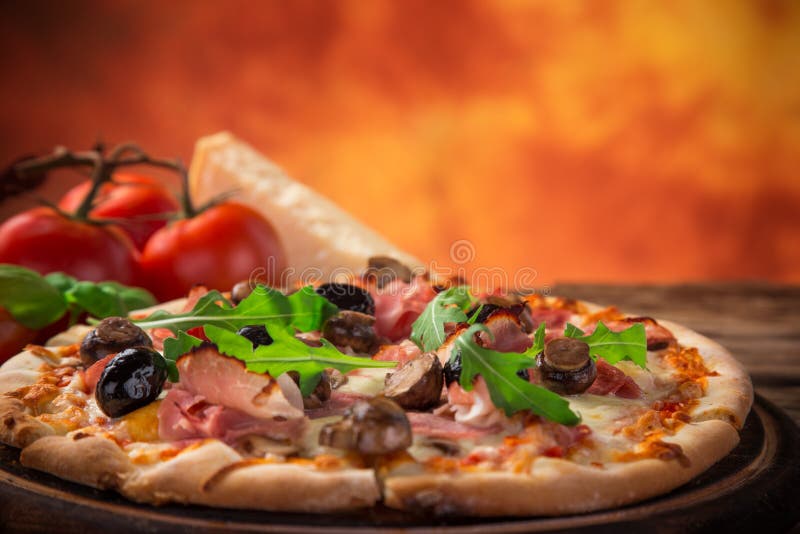 Delicious italian pizza served on wooden table, close-up. Delicious italian pizza served on wooden table, close-up.