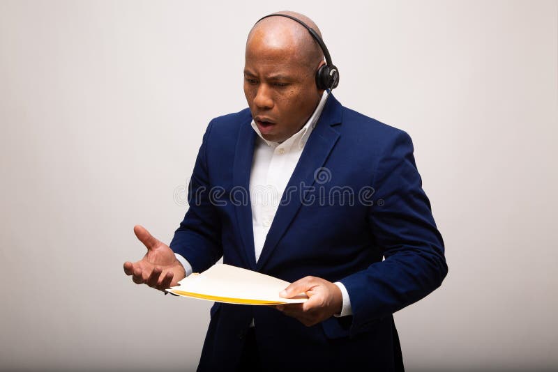Wzburzony amerykanin afryka?skiego pochodzenia biznesmen Opowiada Przez s?uchawki obrazy royalty free Wzburzony amerykanin afryka?skiego pochodzenia biznesmen Opowiada Przez s?uchawki obrazy royalty free
