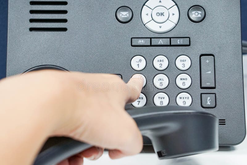 Dial the number pad of IP phone with human left hand. Dial the number pad of IP phone with human left hand