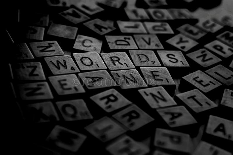 A bunch of scrambled game board pieces with letters imprinted on them, focusing on Words with a shallow depth of field. A bunch of scrambled game board pieces with letters imprinted on them, focusing on Words with a shallow depth of field.