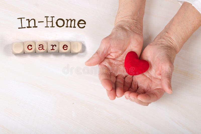 Words IN-HOME CARE composed of wooden dices. Old woman keeps a plush red heart in her palms, 80, years, association, assistance, blood, body, parts, campaign, cardiological, disorder, closeup, concept, female, flat, lay, macro, age, prevention, senior, sign, symbol, top, view, visit, surface. Words IN-HOME CARE composed of wooden dices. Old woman keeps a plush red heart in her palms, 80, years, association, assistance, blood, body, parts, campaign, cardiological, disorder, closeup, concept, female, flat, lay, macro, age, prevention, senior, sign, symbol, top, view, visit, surface