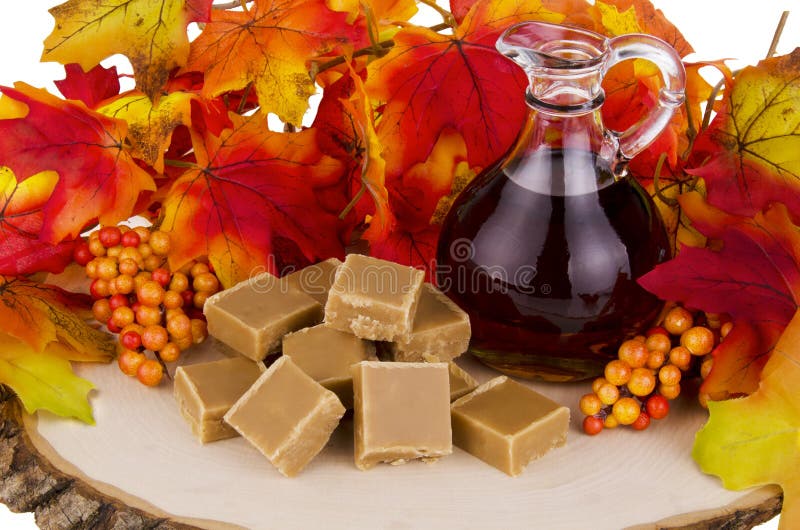 Presentation of maple syrup and sugar cream fudge on wooden plate. Presentation of maple syrup and sugar cream fudge on wooden plate.