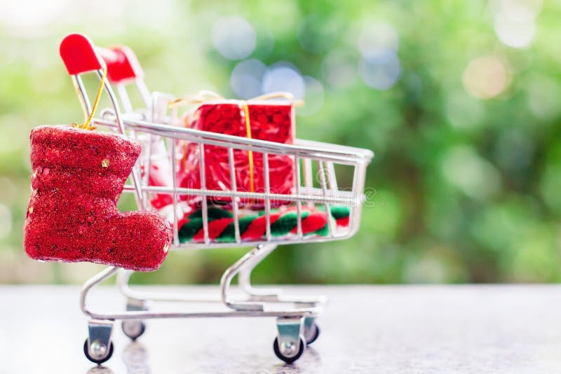 Xmas decorative items in mini shopping cart or trolley against b royalty free stock photography Xmas decorative items in mini shopping cart or trolley against b royalty free stock photography