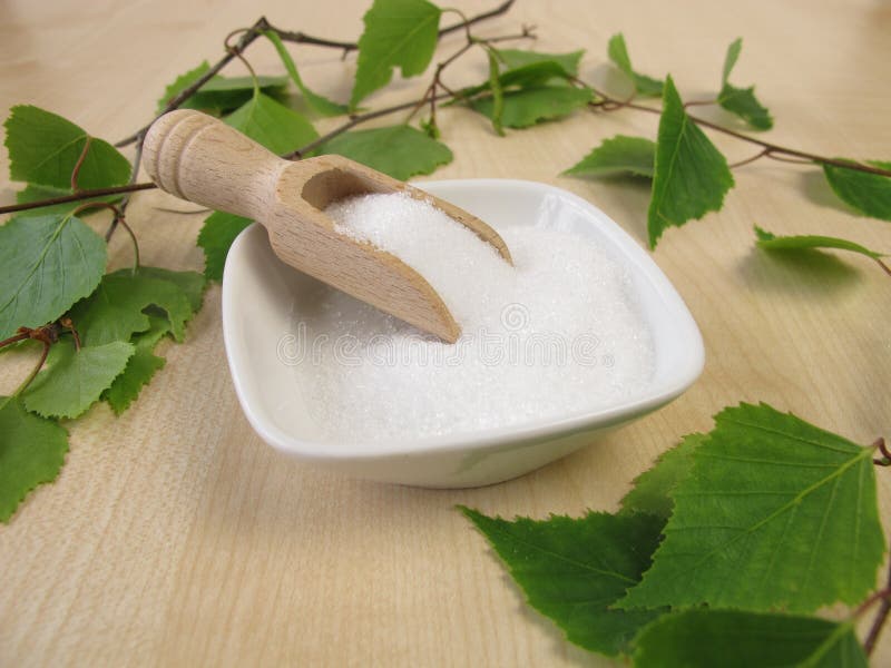 Xylitol Sugar Substitute. Birch Sugar on Blue Wooden Background
