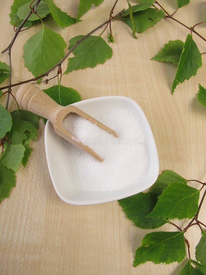 Xylitol Sugar Substitute. Birch Sugar on Blue Wooden Background