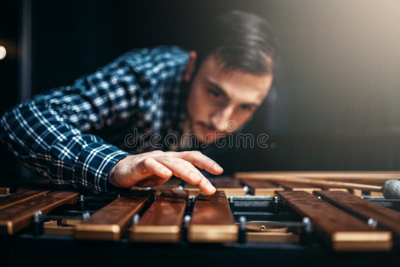 Xylophone player with sticks in hands, musician in action, wooden sounds. Musical percussion instrument, vibraphone. Xylophone player with sticks in hands, musician in action, wooden sounds. Musical percussion instrument, vibraphone