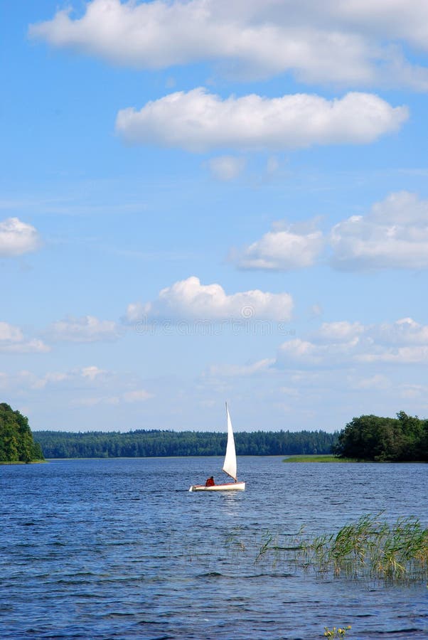 White yacht on the lake surface, Plateliai, Lithuania, travel Europe. White yacht on the lake surface, Plateliai, Lithuania, travel Europe