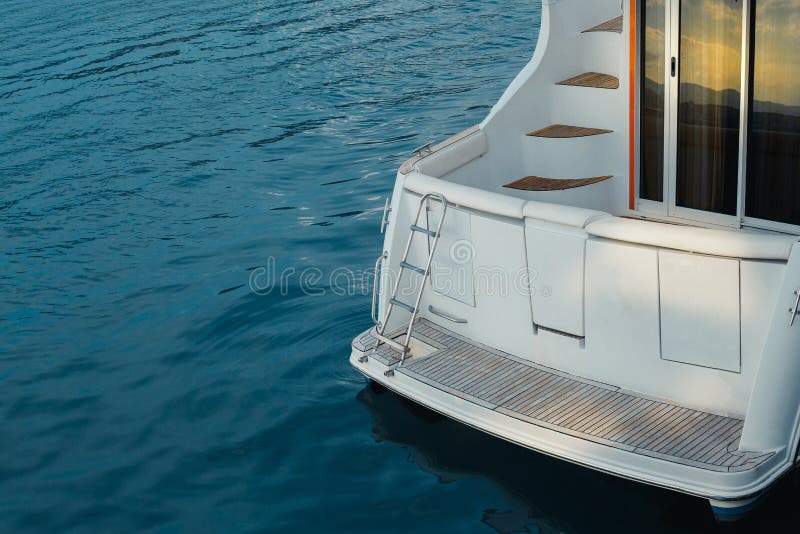 Stern of a motor yacht moored to pier closeup Water Transport Concept. Stern of a motor yacht moored to pier closeup Water Transport Concept