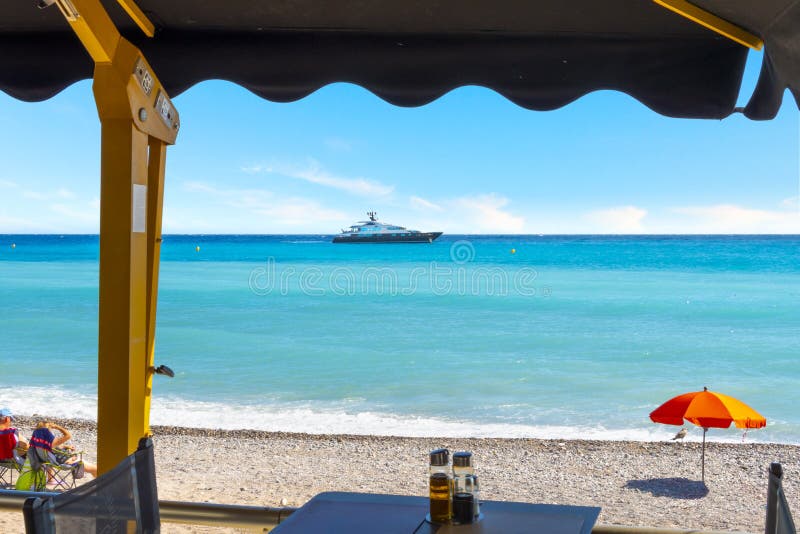 A yacht passes by in front of the Plage de Casino along the Mediterranean coast of Menton, France, on the French Riviera royalty free stock photo A yacht passes by in front of the Plage de Casino along the Mediterranean coast of Menton, France, on the French Riviera royalty free stock photo
