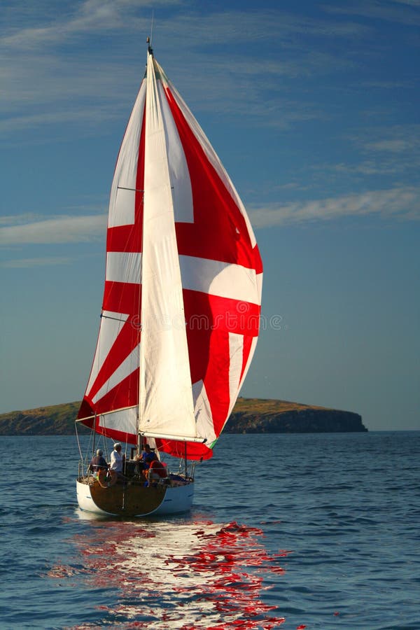 The Yacht with a red sail near island. 2