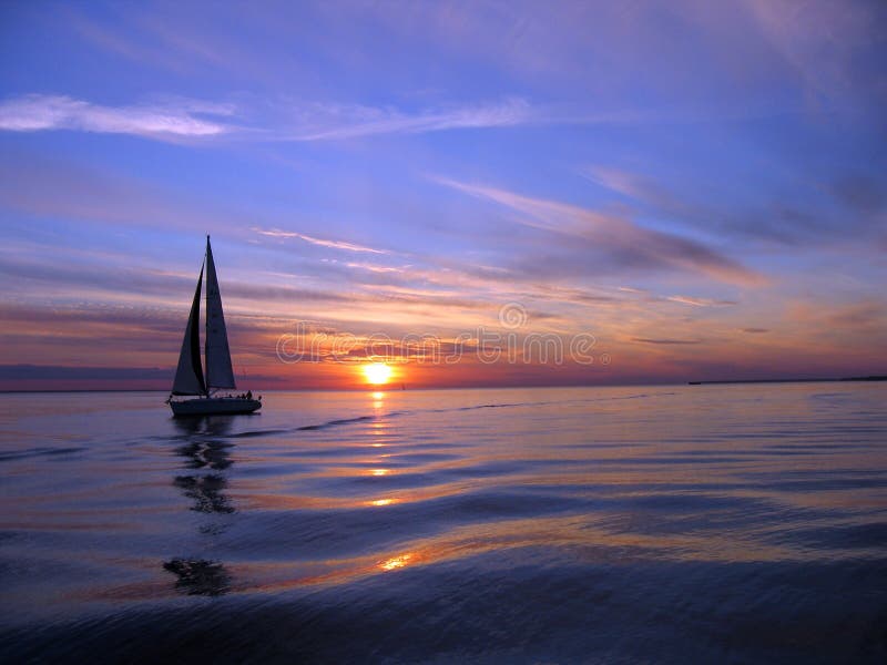 yacht sailing at sunset stock photo. image of calm