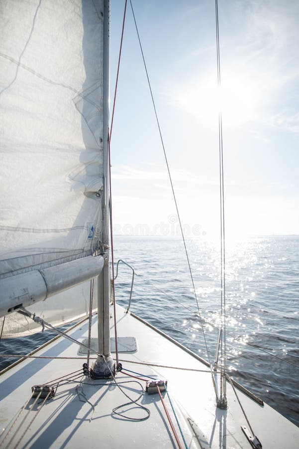 Yacht sailing towards the sunset stock photo Yacht sailing towards the sunset stock photo