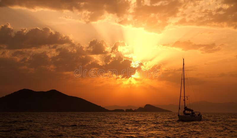 A yacht at the sea during a sunset