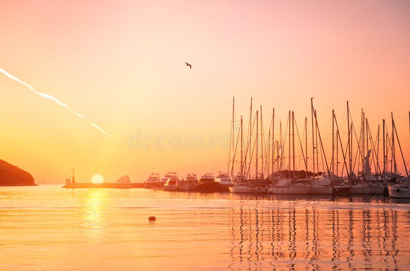 Yachts and boats at Adriatic sea bay at sunset