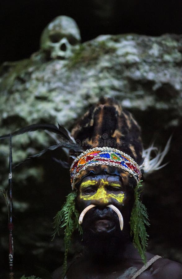 NEW GUINEA, INDONESIA - 2 FEBRUARY: The warrior of a Papuan tribe of Yafi in traditional clothes, ornaments and coloring. New Guinea Island, Indonesia. February 2, 2009. NEW GUINEA, INDONESIA - 2 FEBRUARY: The warrior of a Papuan tribe of Yafi in traditional clothes, ornaments and coloring. New Guinea Island, Indonesia. February 2, 2009.