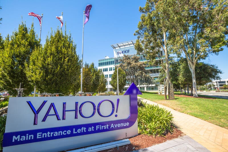 Sunnyvale, California, United States - August 15, 2016: Yahoo Headquarters with American Flag and flag with Yahoo icon on background. Sunnyvale, California, United States - August 15, 2016: Yahoo Headquarters with American Flag and flag with Yahoo icon on background.