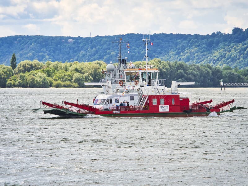 Red ferry on the Seine river with the forest background