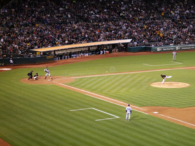 OAKLAND - JULY 7: Yankees 6 vs A's 2: Yankee Alex Rodriguez stands in batters box ready to swing with Oakland A's Kurt Suzuki catching as pitcher throws ball which can be seen in the air at the Coliseum in Oakland California on July 7 2010.