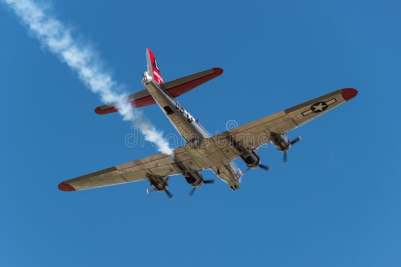 EDEN PRAIRIE, MN - JULY 16 2016: B-17G bomber Yankee Lady flies overhead with smoke trail at air show. This B-17 was a Flying Fortress built for use during WW II but never flew in any combat missions.