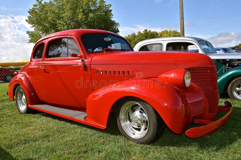 YANKTON, SOUTH DAKOTA, August 16, 2019: A classic red restored 1939 Chevrolet coupe is displayed at the annual car show as Riverboat Days celebrates on the third weekend of August. YANKTON, SOUTH DAKOTA, August 16, 2019: A classic red restored 1939 Chevrolet coupe is displayed at the annual car show as Riverboat Days celebrates on the third weekend of August.