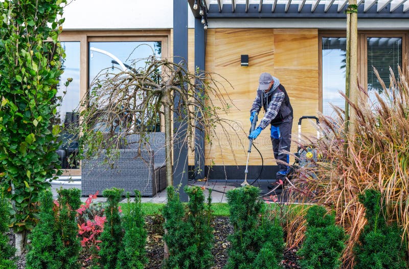 Yard Work Takes Place at a Residential Home in the Daytime royalty free stock photos