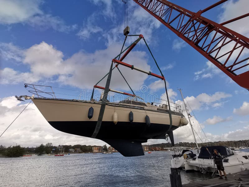 Yacht being craned into water. Yacht being craned into water