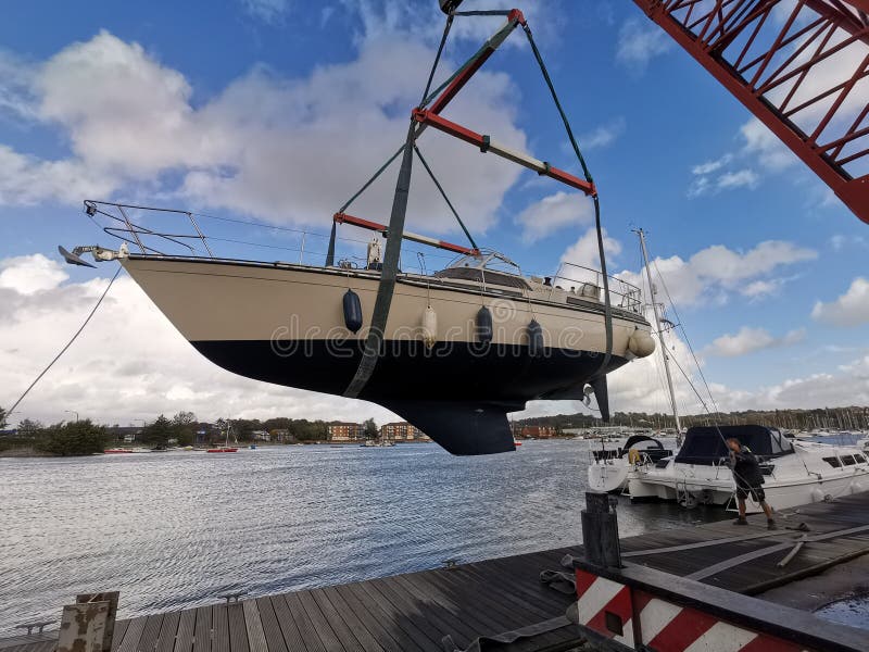 Yacht being craned into water. Yacht being craned into water