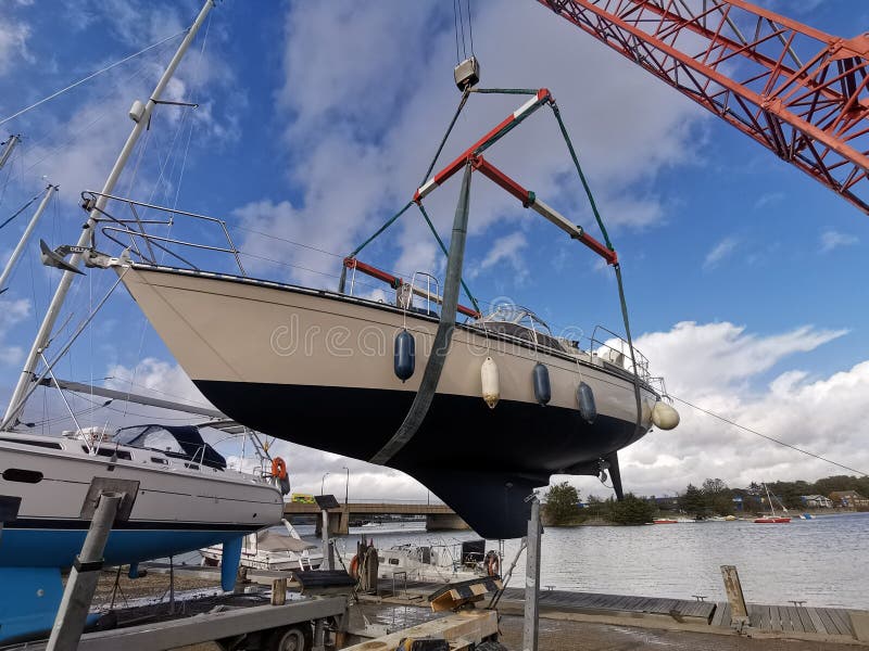 Yacht being craned into water. Yacht being craned into water