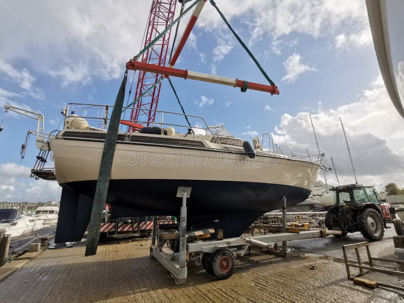 Yacht being craned into water. Yacht being craned into water