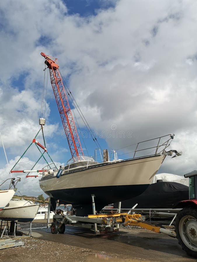 Yacht being craned into water. Yacht being craned into water
