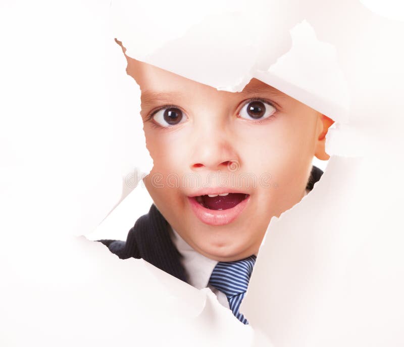 Yawning kid looks up through a hole in white paper. Boring kid white stock images, royalty-free photos and pictures
