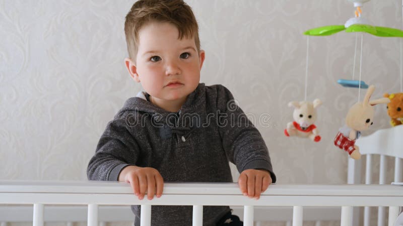 1-2 year old baby having fun in the crib at home