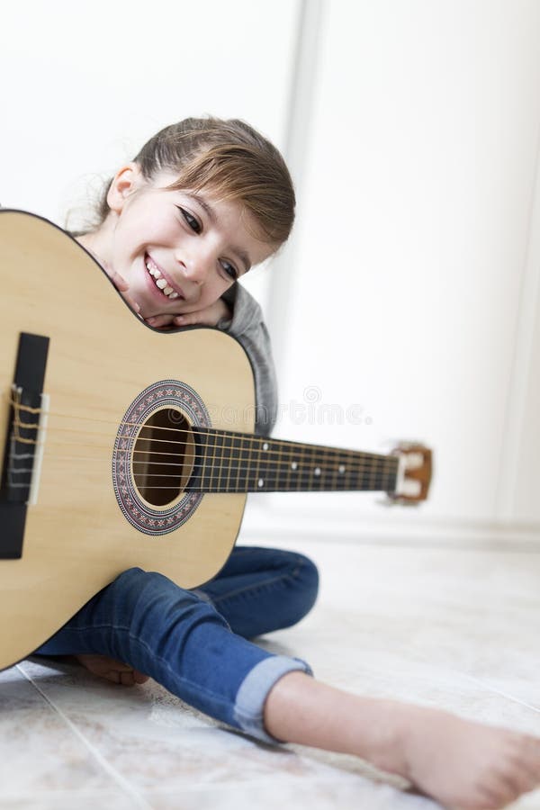 9 year old girl learning to play the guitar. royalty free stock images 9 year old girl learning to play the guitar. royalty free stock images