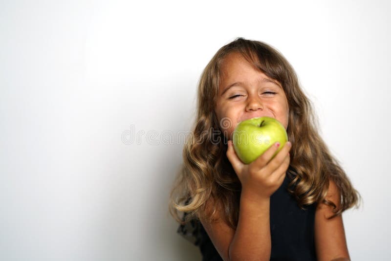 4 year old Italian girl eats a green apple