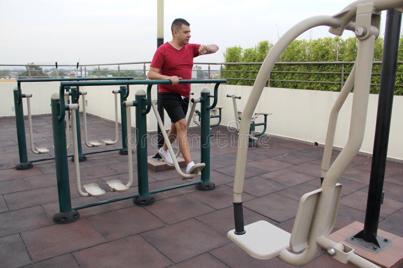 40 year old Man Exercises On The Roof Garden Of His Building With 40-year-old-man-exercises-on-the-roof-garden-of-his-building-with