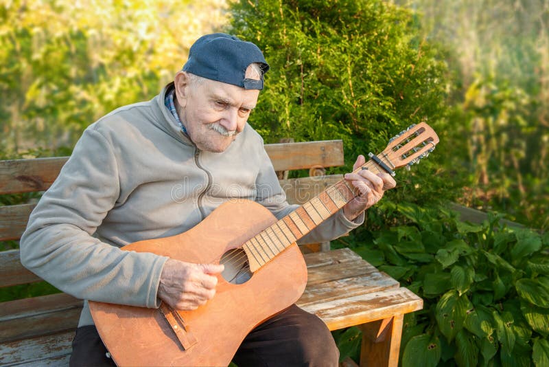 87 Year Old Mustachioed Man Plays An Acoustic Guitar Outdoors In The Garden Old Man Of 