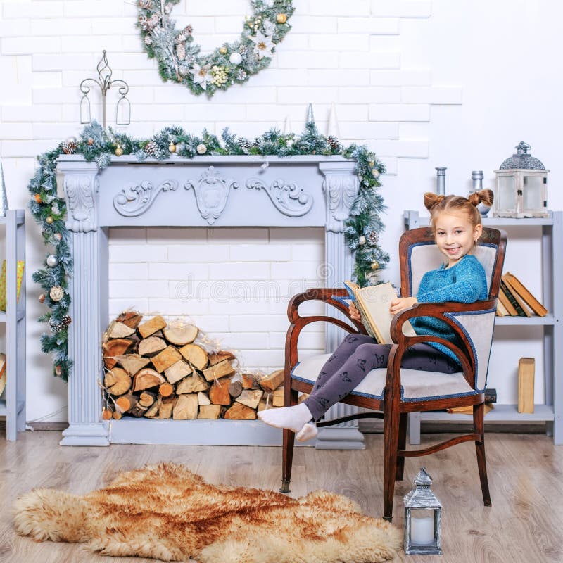 5 years old little girl reading book with winter tales from Claus. Square. stock images 5 years old little girl reading book with winter tales from Claus. Square. stock images