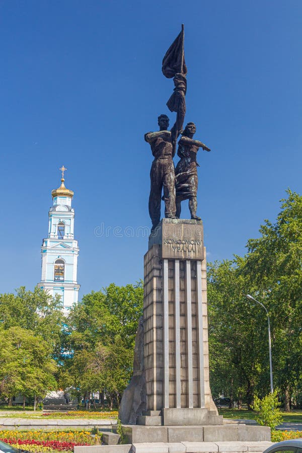 YEKATERINBURG, RUSSIA - JULY 3, 2018: Monument to the Komsomol of Ural and the Bell tower of the Ascension church in Yekaterinburg, Russia