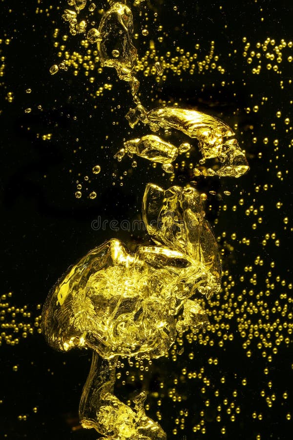 Yellow colored air bubbles rising in water. Yellow colored air bubbles rising in water.