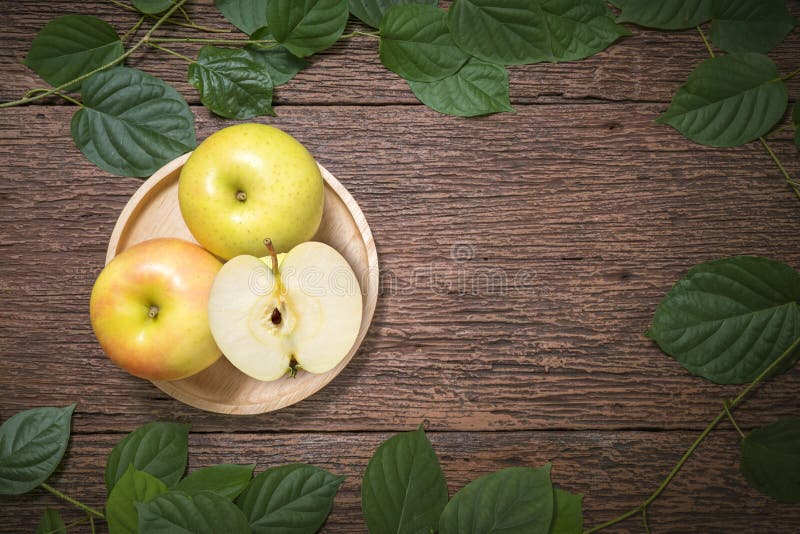 Yellow apple fruit on wooden Background, Toki apples on the old wooden table.