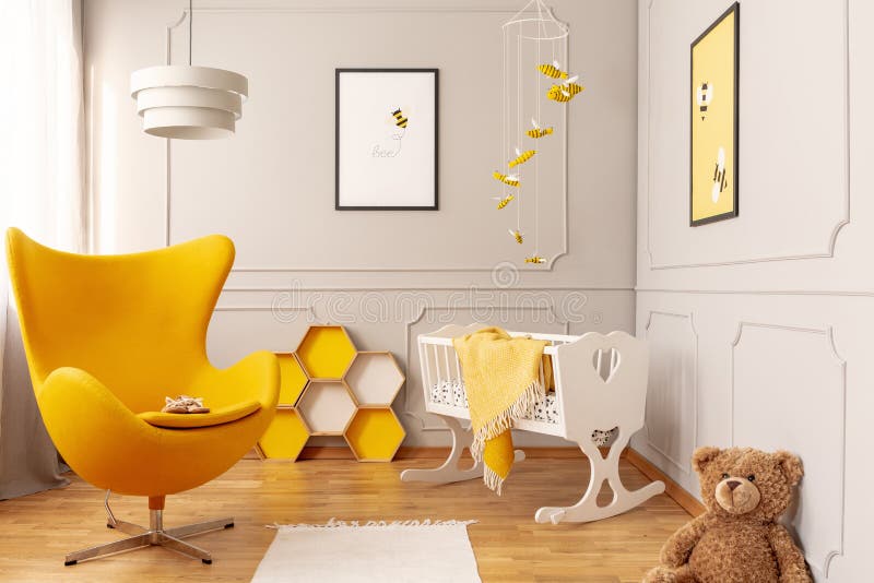Yellow armchair, honeycombs and crib in a toddler room interior. Real photo stock images Yellow armchair, honeycombs and crib in a toddler room interior. Real photo stock images