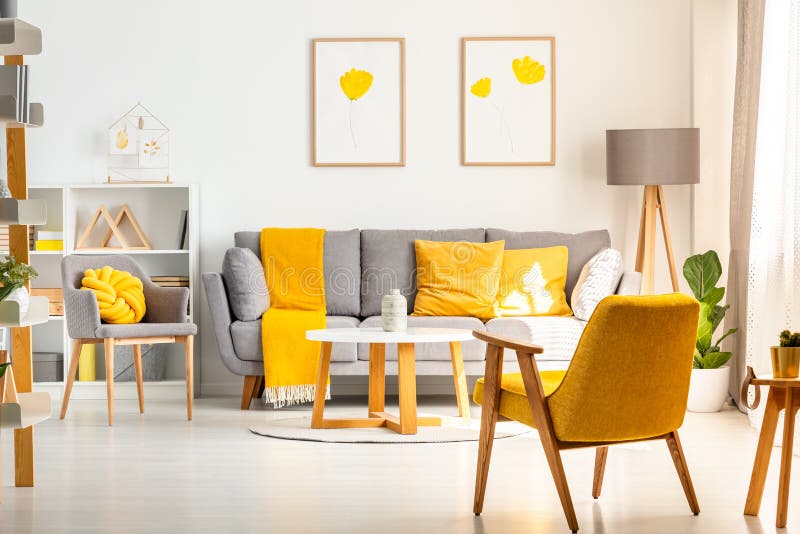Yellow armchair in white living room interior with posters above stock photo Yellow armchair in white living room interior with posters above stock photo