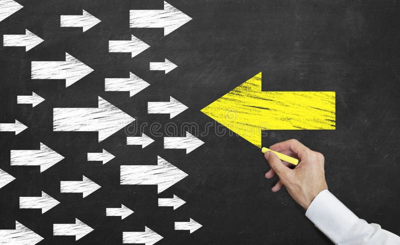 Yellow arrow leading to different direction on the blackboard with chalk royalty free stock photography