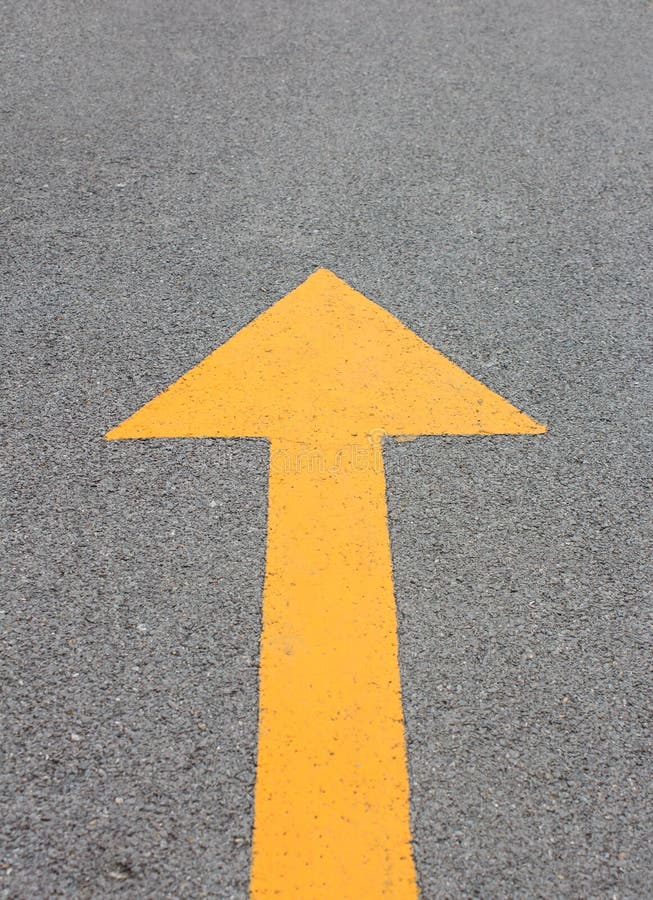 Yellow arrow up on asphalt street stock image