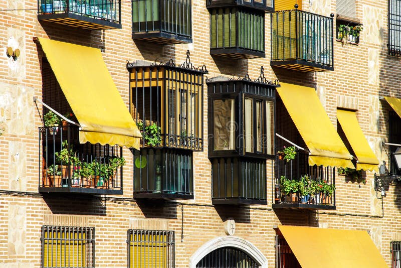 Yellow awnings on house wall royalty free stock photo