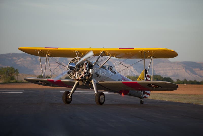 Yellow biplane sitting on runway