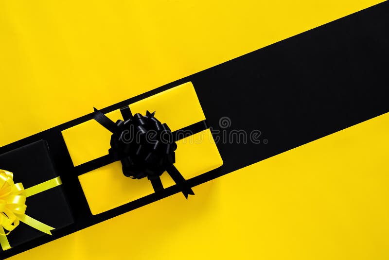 Yellow and Black Gift Boxes with Ribbon Put on Black and Yellow