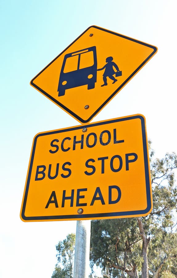 Yellow and black school bus stop ahead sign and blue sky royalty free stock image Yellow and black school bus stop ahead sign and blue sky royalty free stock image