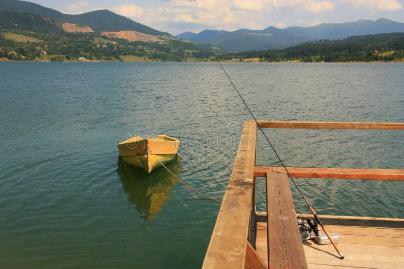 Yellow boat on the mountain see royalty free stock photo